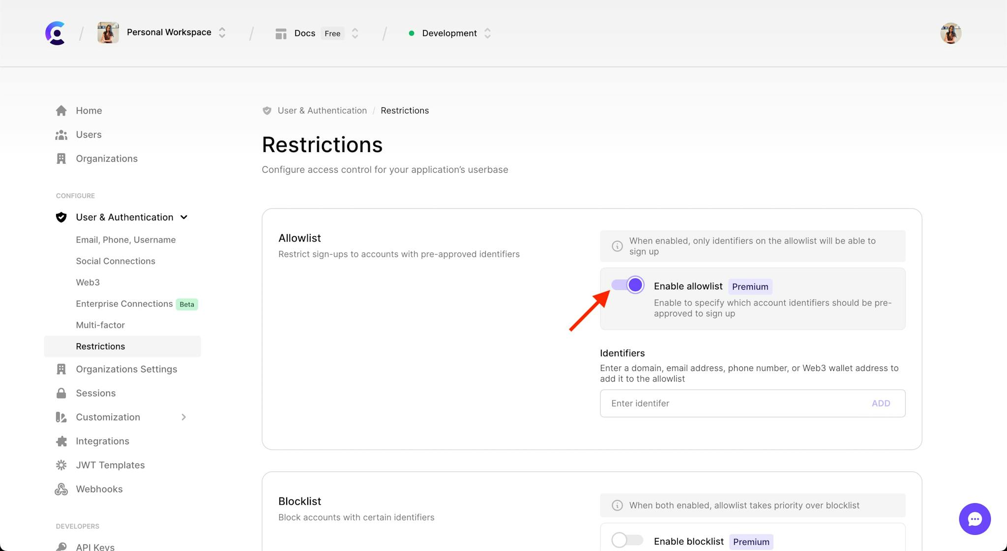 The 'Allowlist' section in the 'Restrictions' tab under the 'User & Authentication' section of the Clerk Dashboard. A red arrow is pointing to the 'Enable allowlist' toggle, which is toggled on.